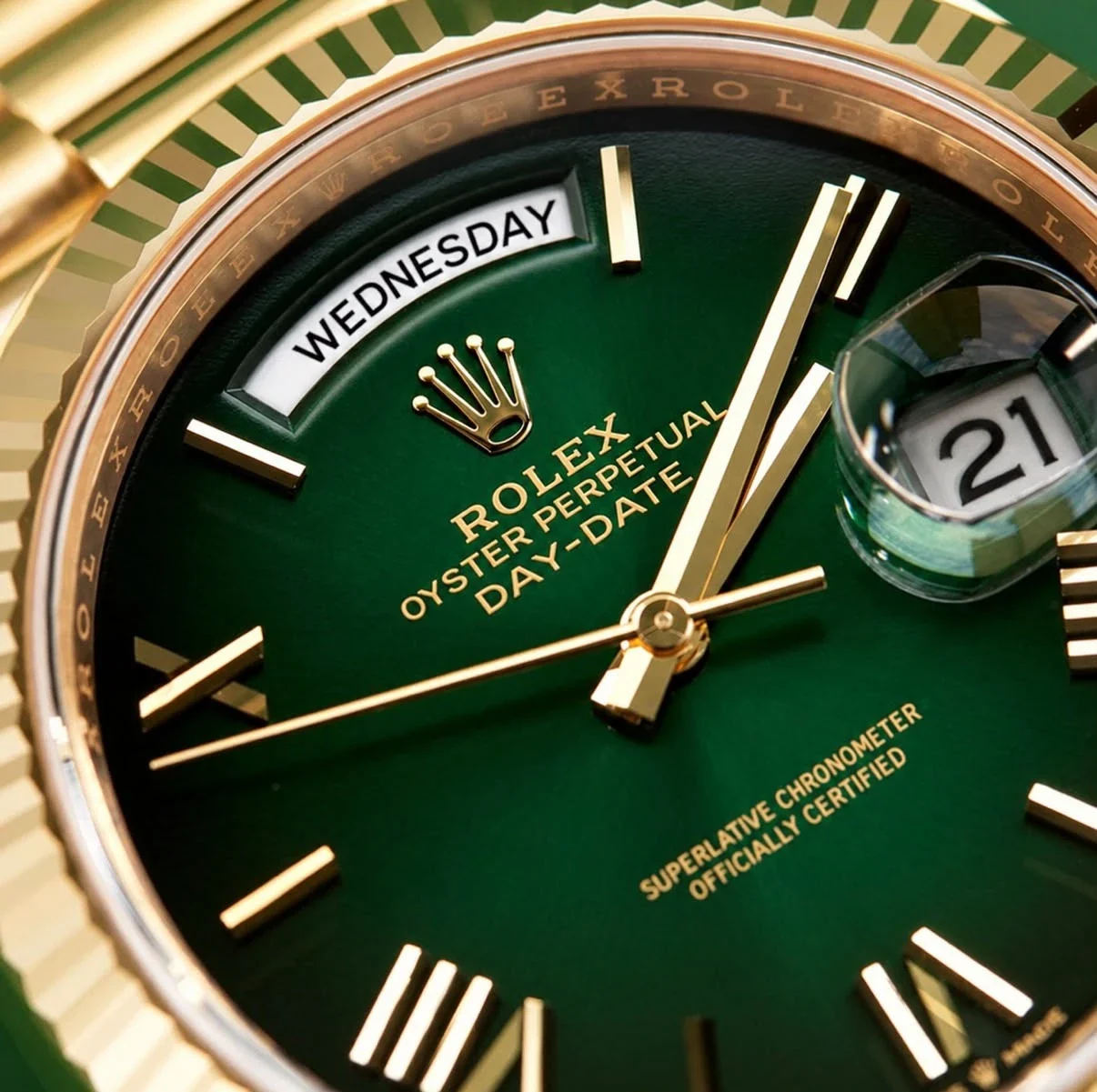 The green ombré dial in close-up, WEDNESDAY in the day window at twelve